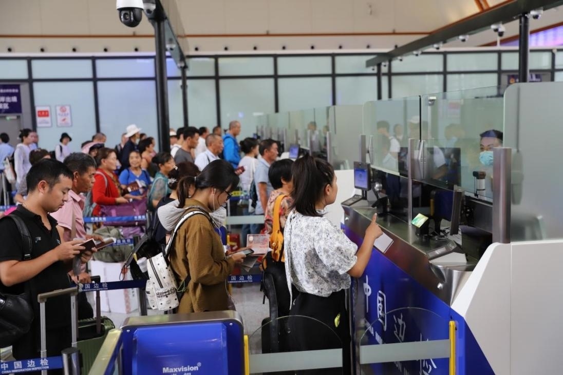 出境旅客在辦理通關(guān)手續(xù)。人民網(wǎng)記者 李發(fā)興攝