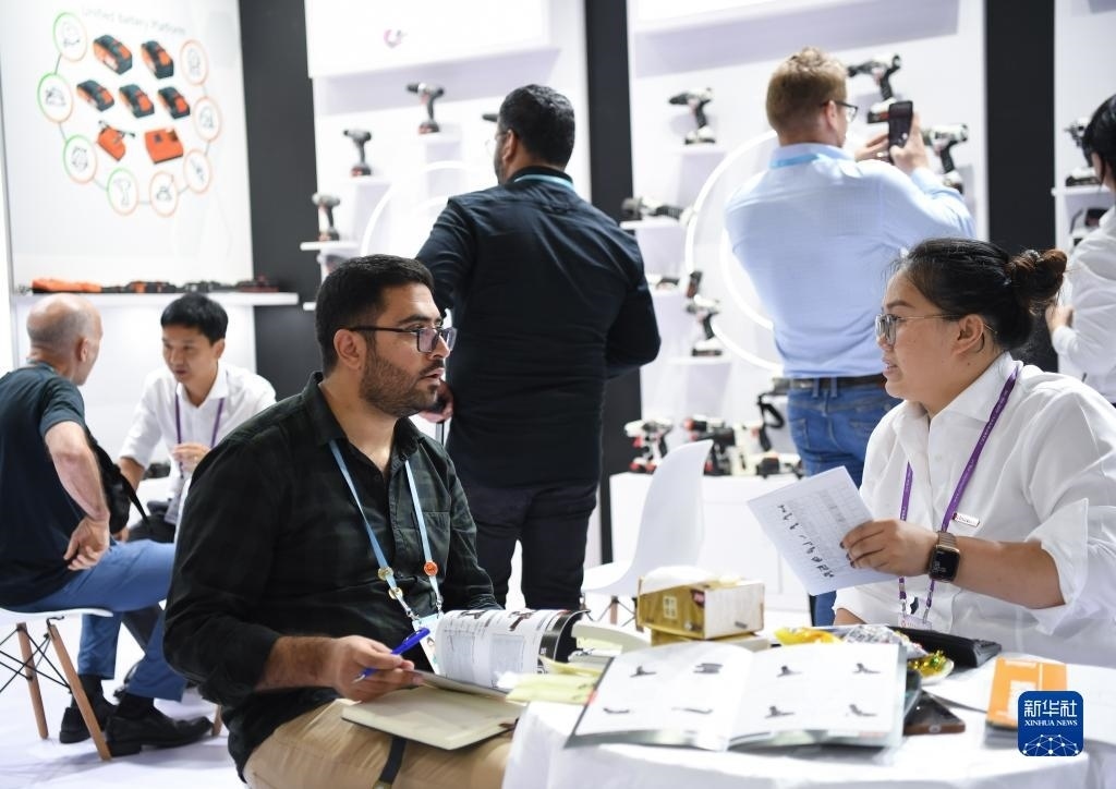 10月15日，在一家電動(dòng)工具展臺(tái)，外國(guó)采購(gòu)商在洽談業(yè)務(wù)。新華社記者 鄧華 攝