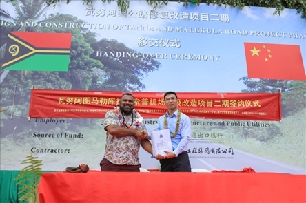 2023年12月18日，瓦努阿圖基礎(chǔ)設(shè)施和公共事業(yè)部長(zhǎng)瑞克·查馬克·馬赫（左）和中土南太公司總經(jīng)理梁慶（右）在馬勒庫(kù)拉諾索普機(jī)場(chǎng)升級(jí)改造二期項(xiàng)目的簽約儀式上握手。人民網(wǎng) 賀吉攝