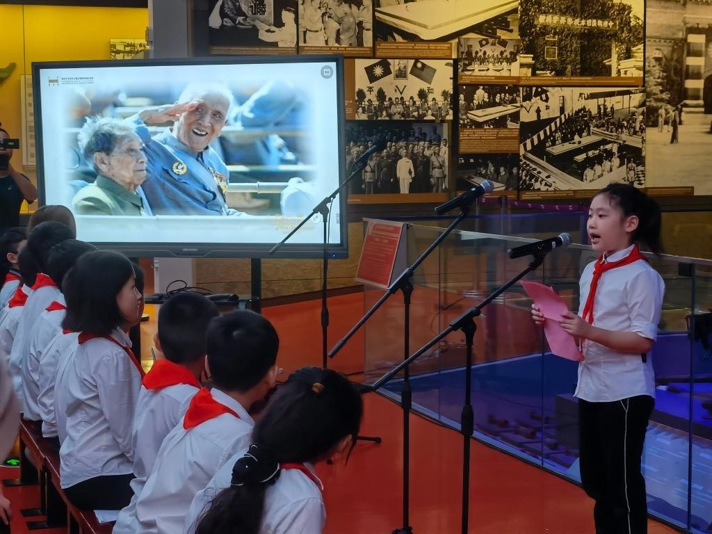 南京市科睿小學(xué)二年級學(xué)生章若初為大家講述抗戰(zhàn)老兵手印的故事。 新華社記者 邱冰清 攝
