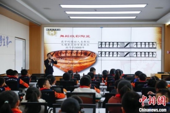 圖為學生在“國寶音樂會”社教課中了解舞蹈紋彩陶盆。中新社記者 馬銘言 攝