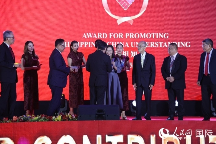 黃溪連大使給榮獲“重要貢獻獎”的奎松市市長喬伊·貝蒙蒂等人頒獎。人民網(wǎng)記者 樊帆攝